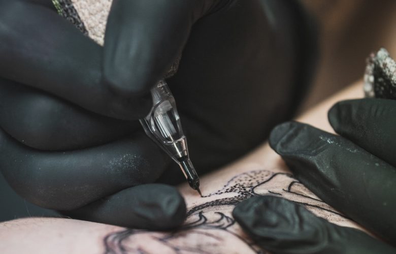 person doing tattoo